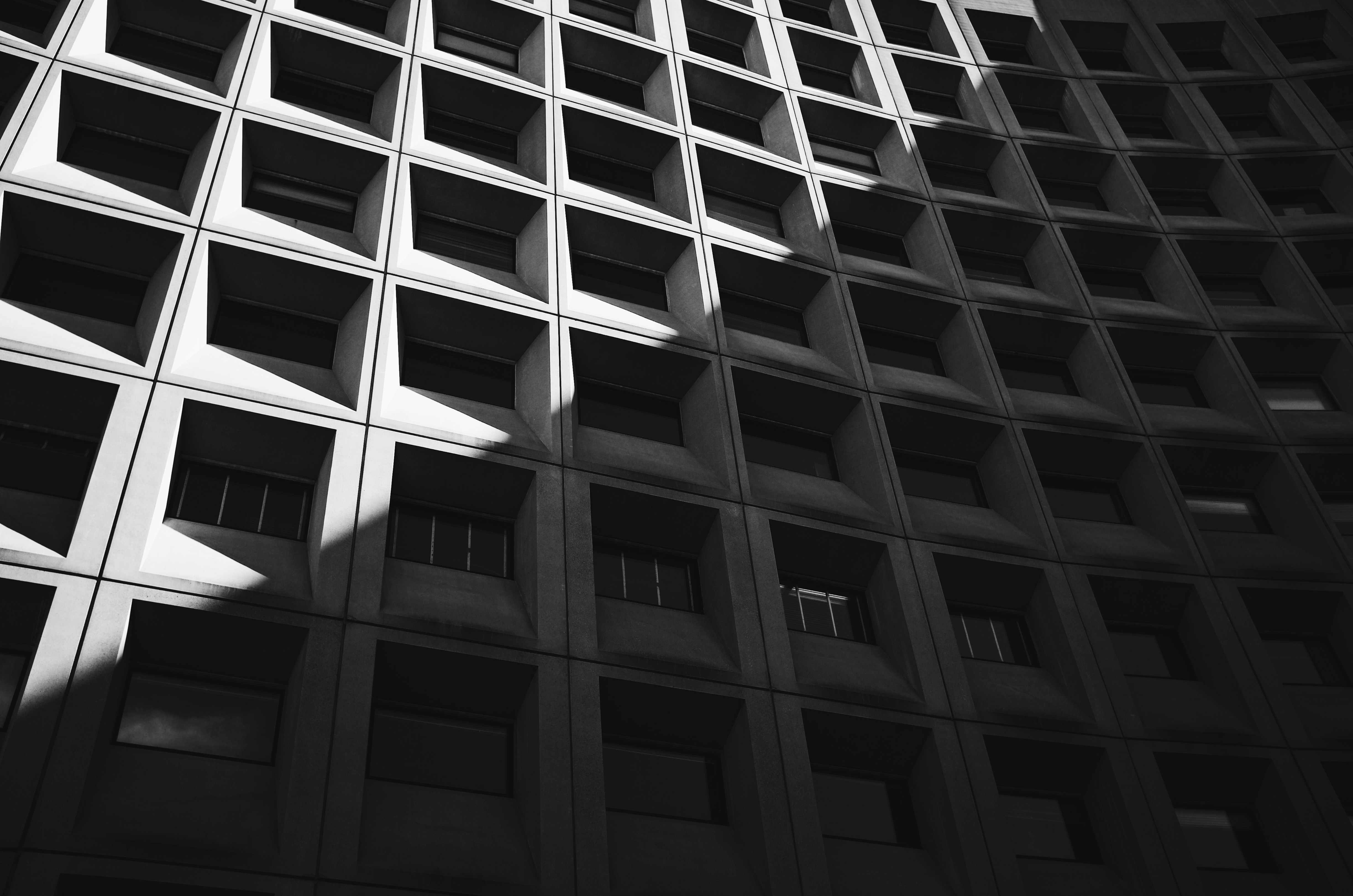 Fig 4.0 · Brutalist concrete corporate facade, geometric repetition