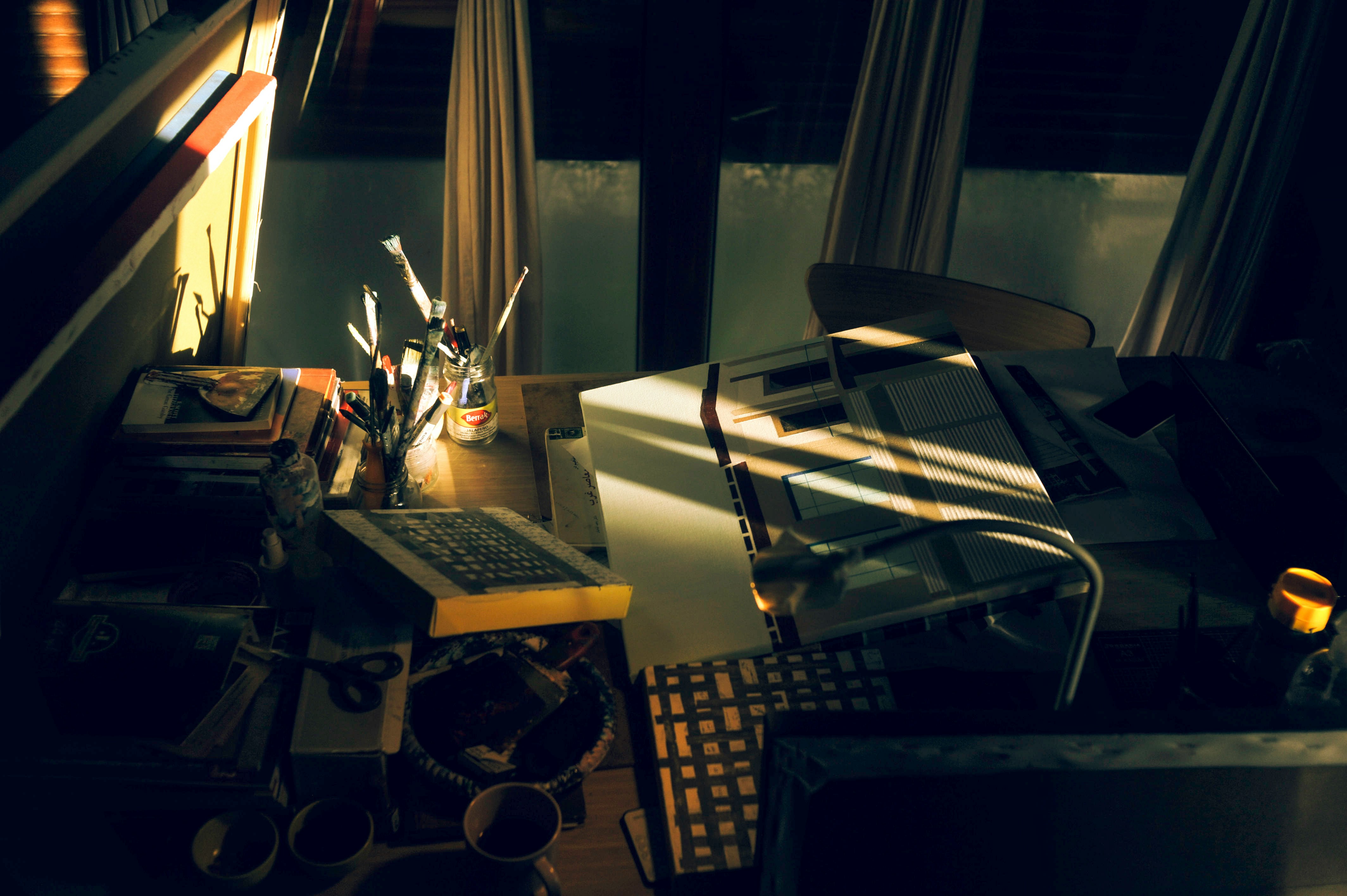 Fig 6.0 · Architect reviewing technical blueprints at drafting table